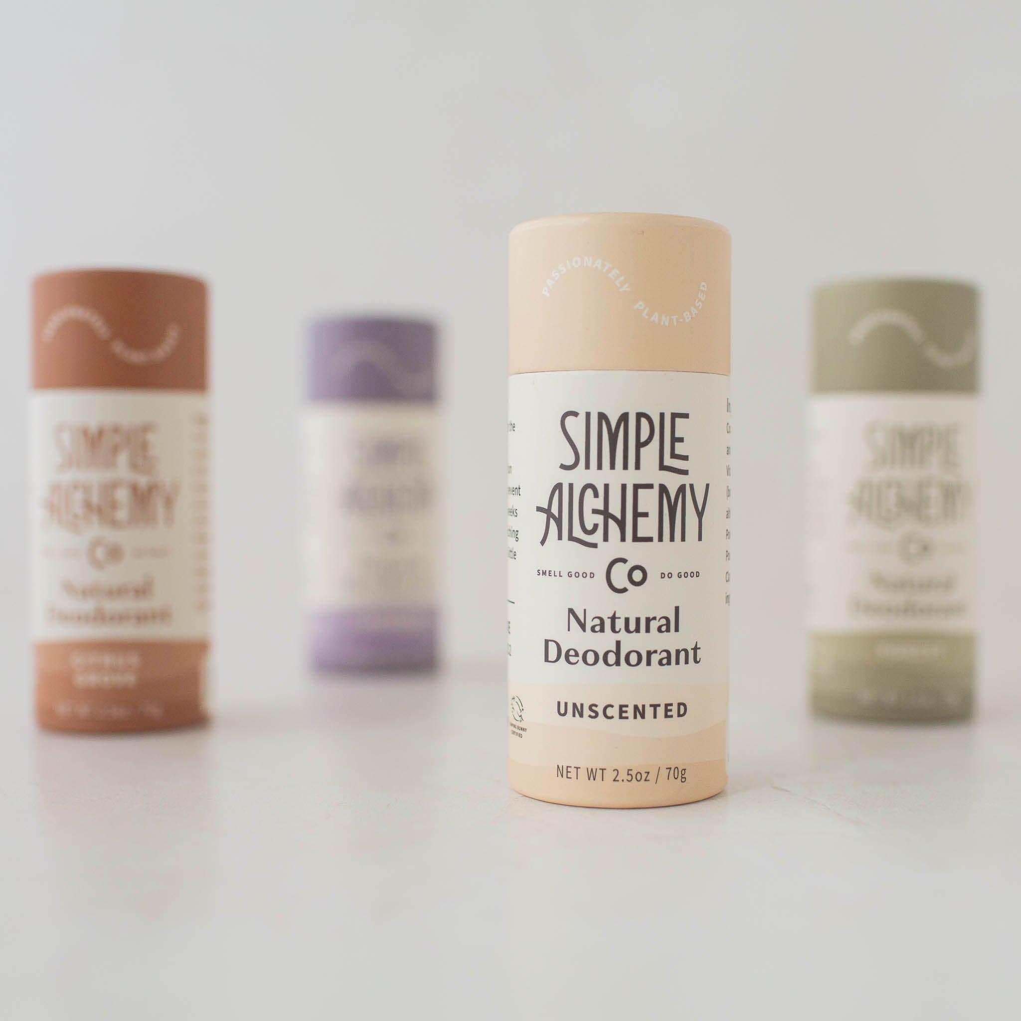 Cream colored compostable paper push-up tube of Unscented Natural Deodorant shown with other scents.