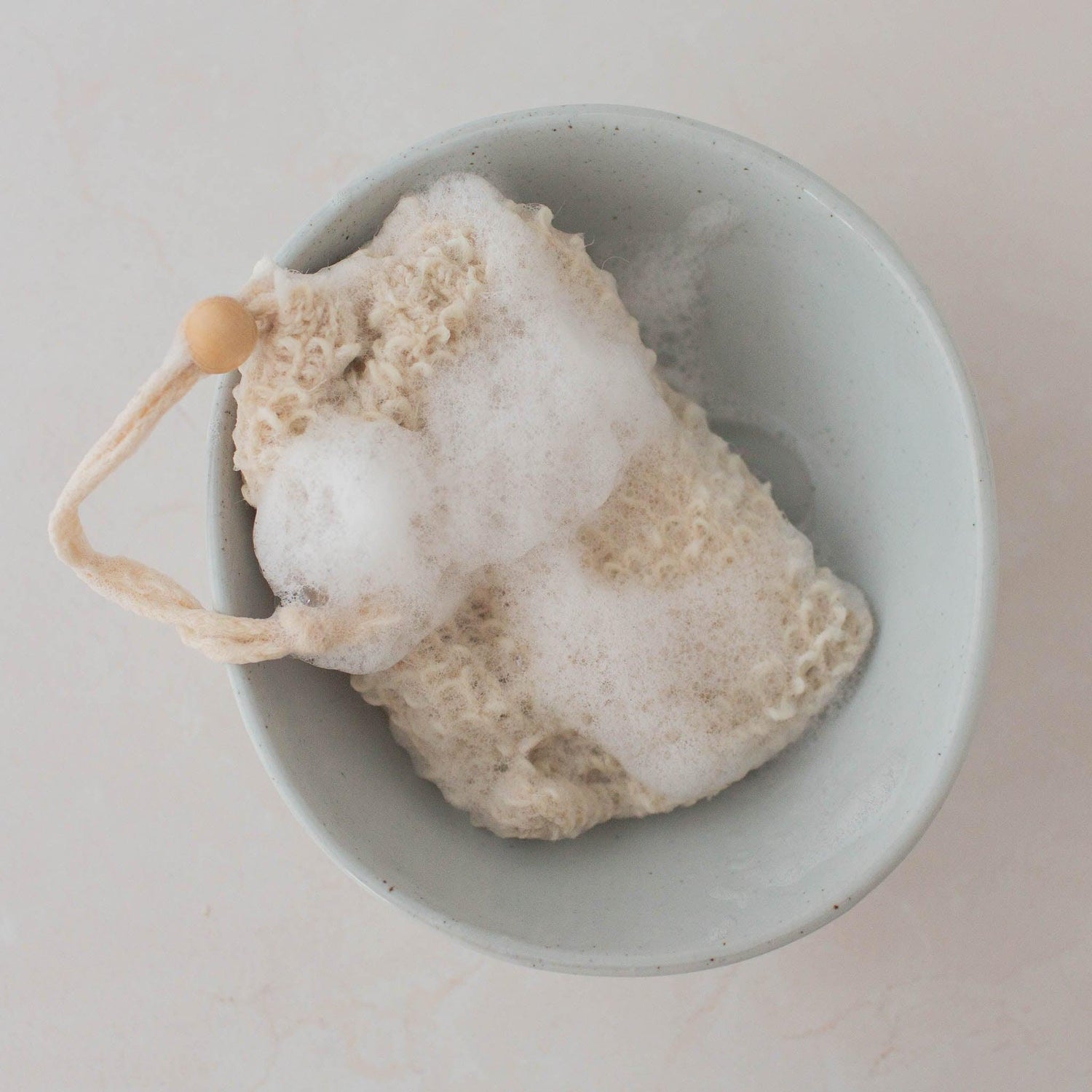 Natural sisal soap holder pouch with exfoliating texture and rich lather.