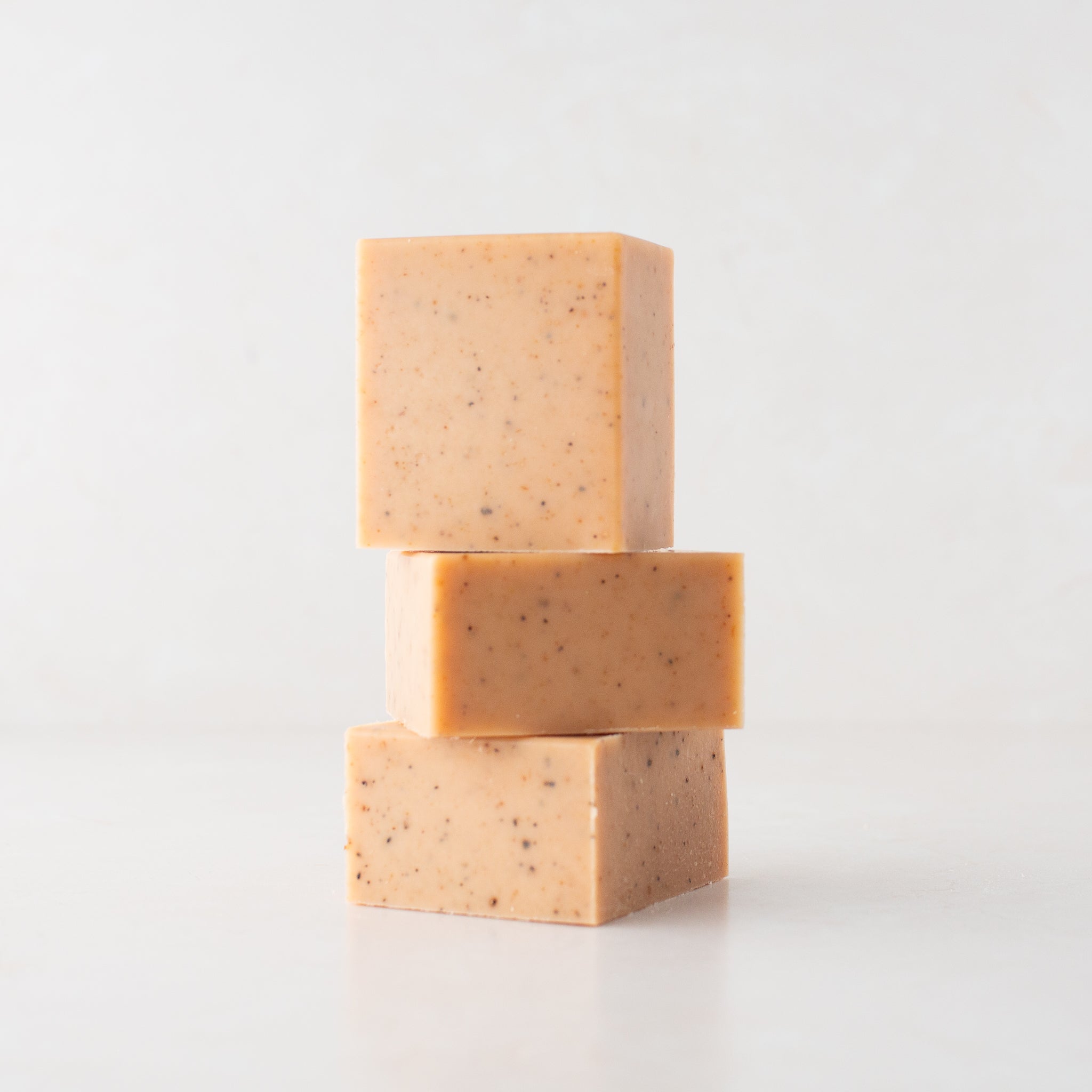 A trio of pale, earthy orange Citrus Solid Dish Soap sample halves.