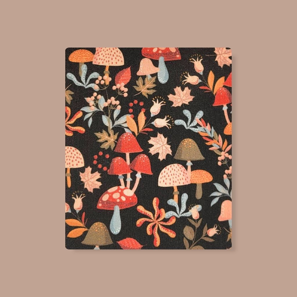 Warm, colorful Swedish dishcloth with mushrooms and leaves illustration, sustainable kitchen swap.