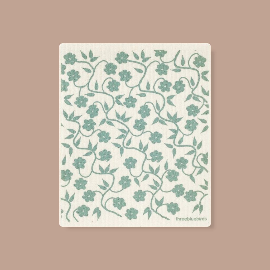 Zero-waste cleaning cloth with pale turquoise flowering vines, perfect for everyday spills.