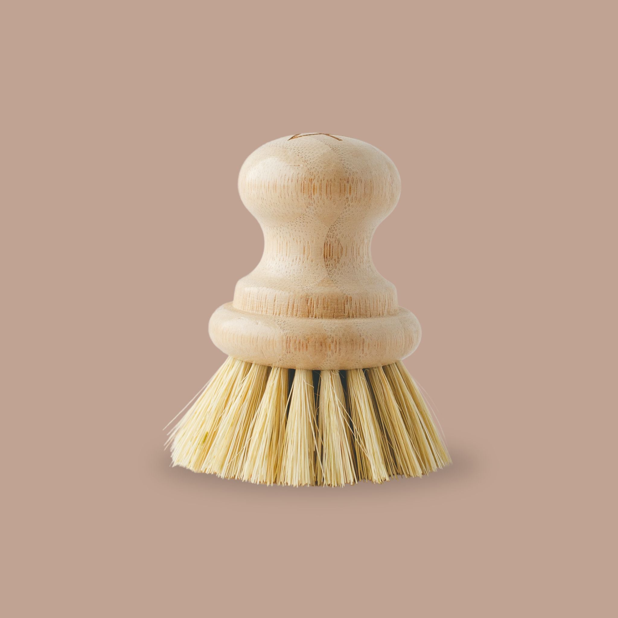 Dish scrub brush with natural fiber bristles for non-toxic cleaning.