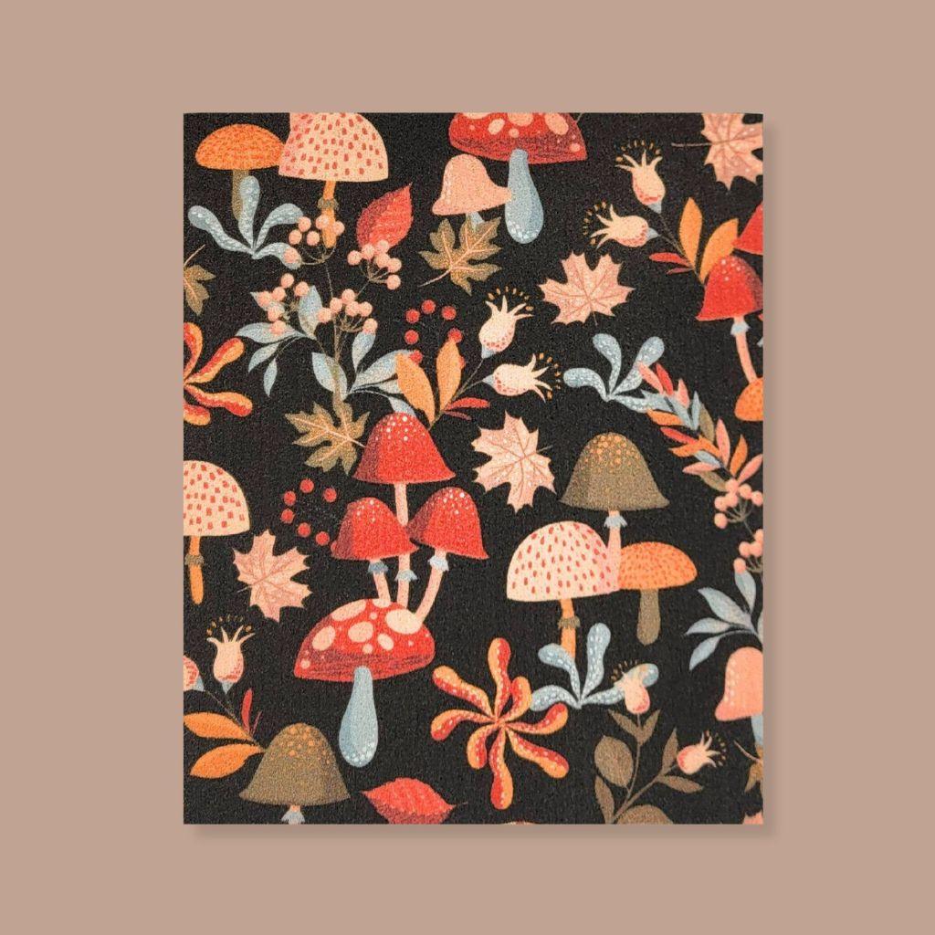 Warm, colorful Swedish dishcloth with mushrooms and leaves illustration, sustainable kitchen swap.
