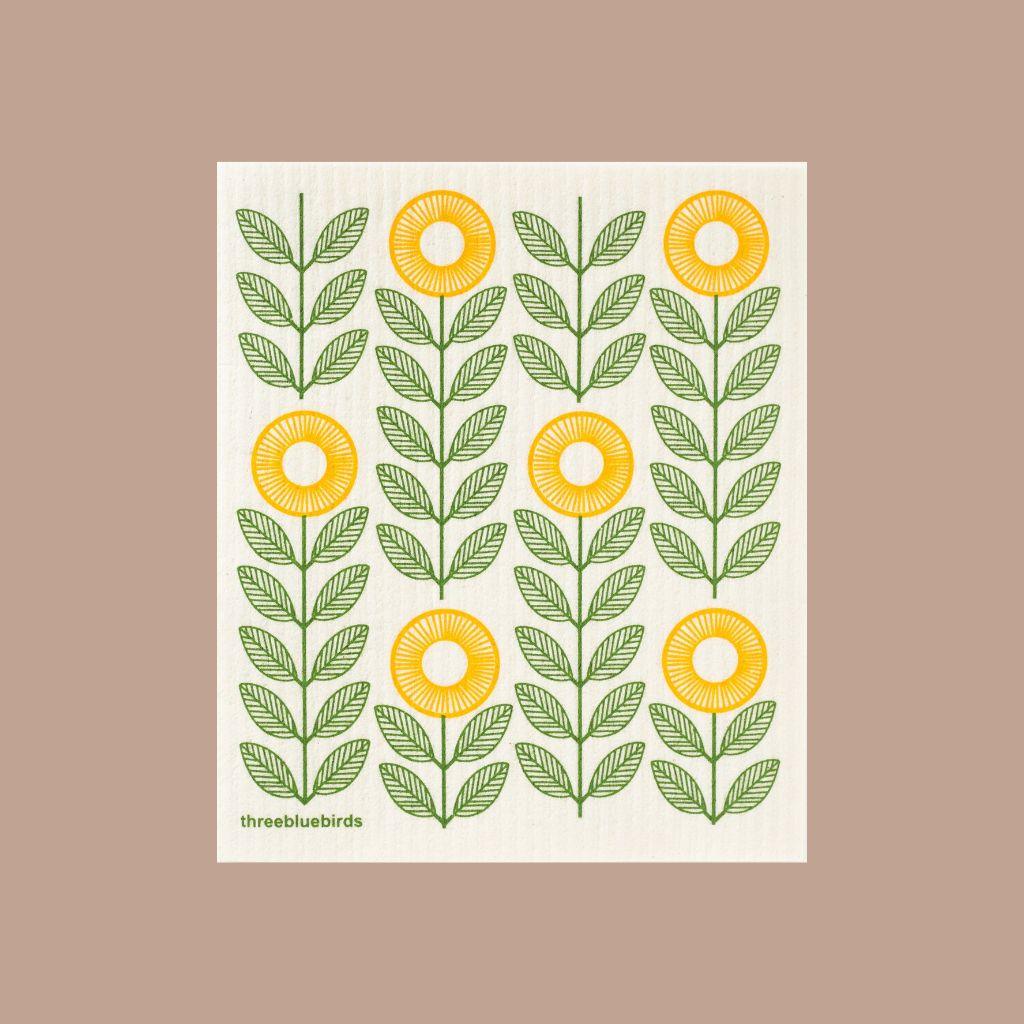 Durable Swedish dishcloth featuring green and yellow sunflower design, gentle on dishes and surfaces.