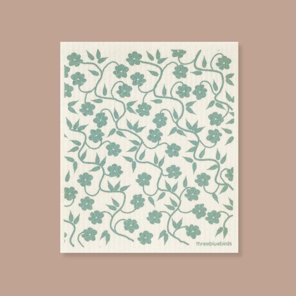 Zero-waste cleaning cloth with pale turquoise flowering vines, perfect for everyday spills.