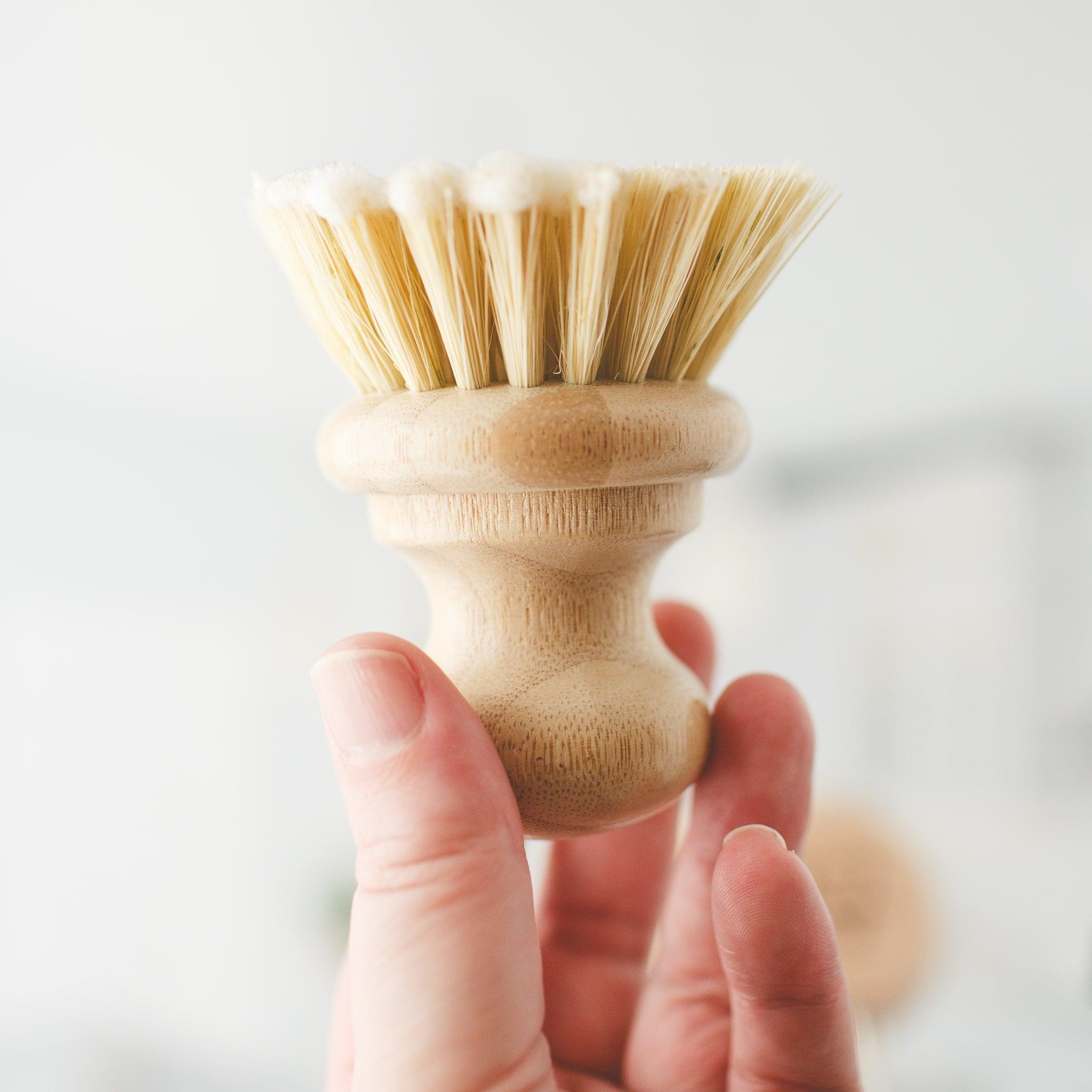 Zero waste kitchen dish brush with natural bristles for sustainable cleaning.