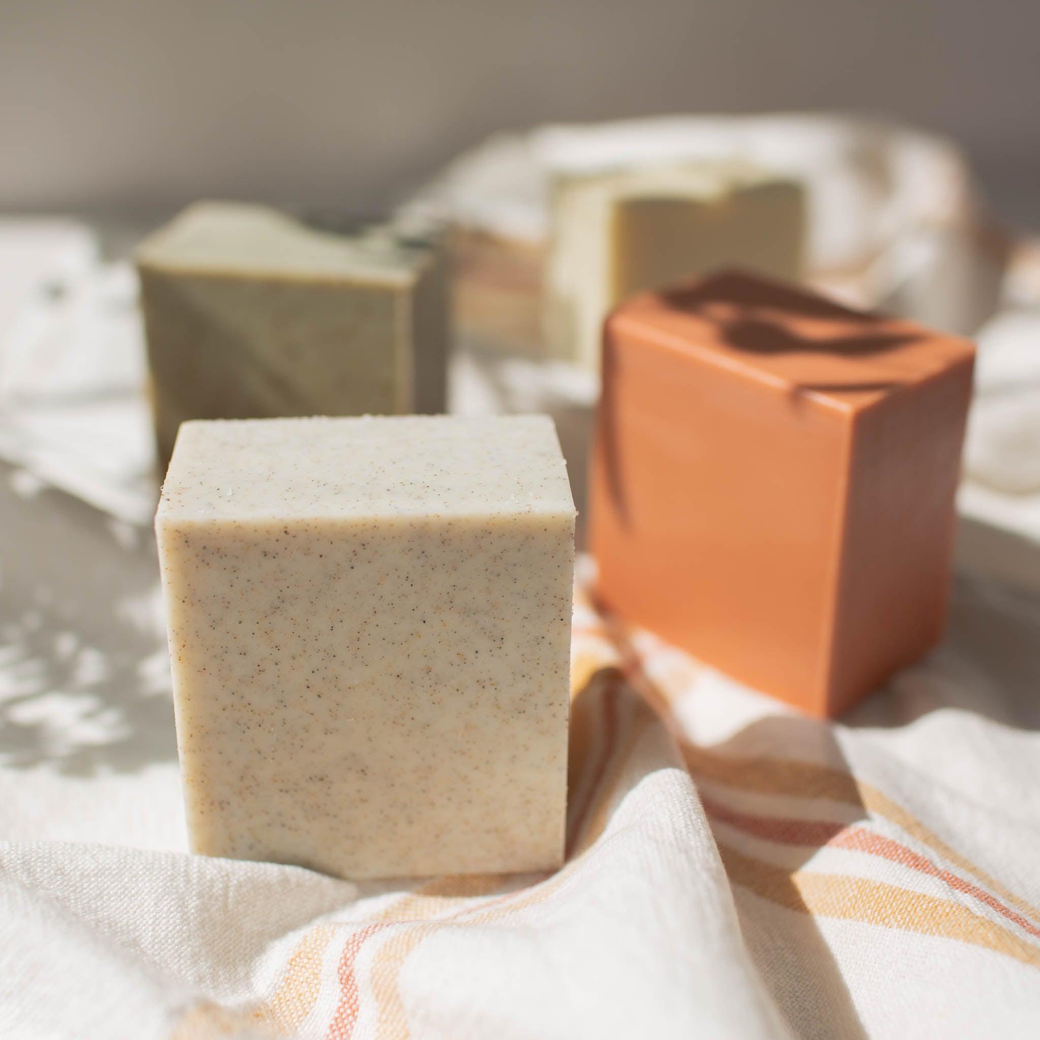 Vegan Scrub Bar Soap soap made with Oregon Coast sand, shown with other kinds of soap.